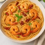 A creamy bowl of Marry Me Shrimp Pasta with linguine, sautéed shrimp, sun-dried tomatoes, basil, and parmesan.