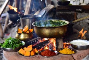 Traditional brass utensils cooking Mandyali Dham over wood fire in Himachal style