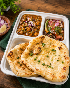 Authentic Channa Kulche served with soft buttered kulchas, spicy chickpea curry, tangy onion salad and green chutney, presented as a classic North Indian street food meal.