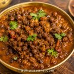 create 3 d vibrant colours using high resolution photographic image authenticated kale chane ka khatta of kangra dham. write watermark "madhusavara.com" at the end of image and no other logo