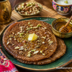 Aktori Recipe | Traditional Himachali Aktori Bread | Buckwheat Pancake 1 Himachali Aktori pancakes served with ghee, honey, nuts and curd on a traditional table setting.