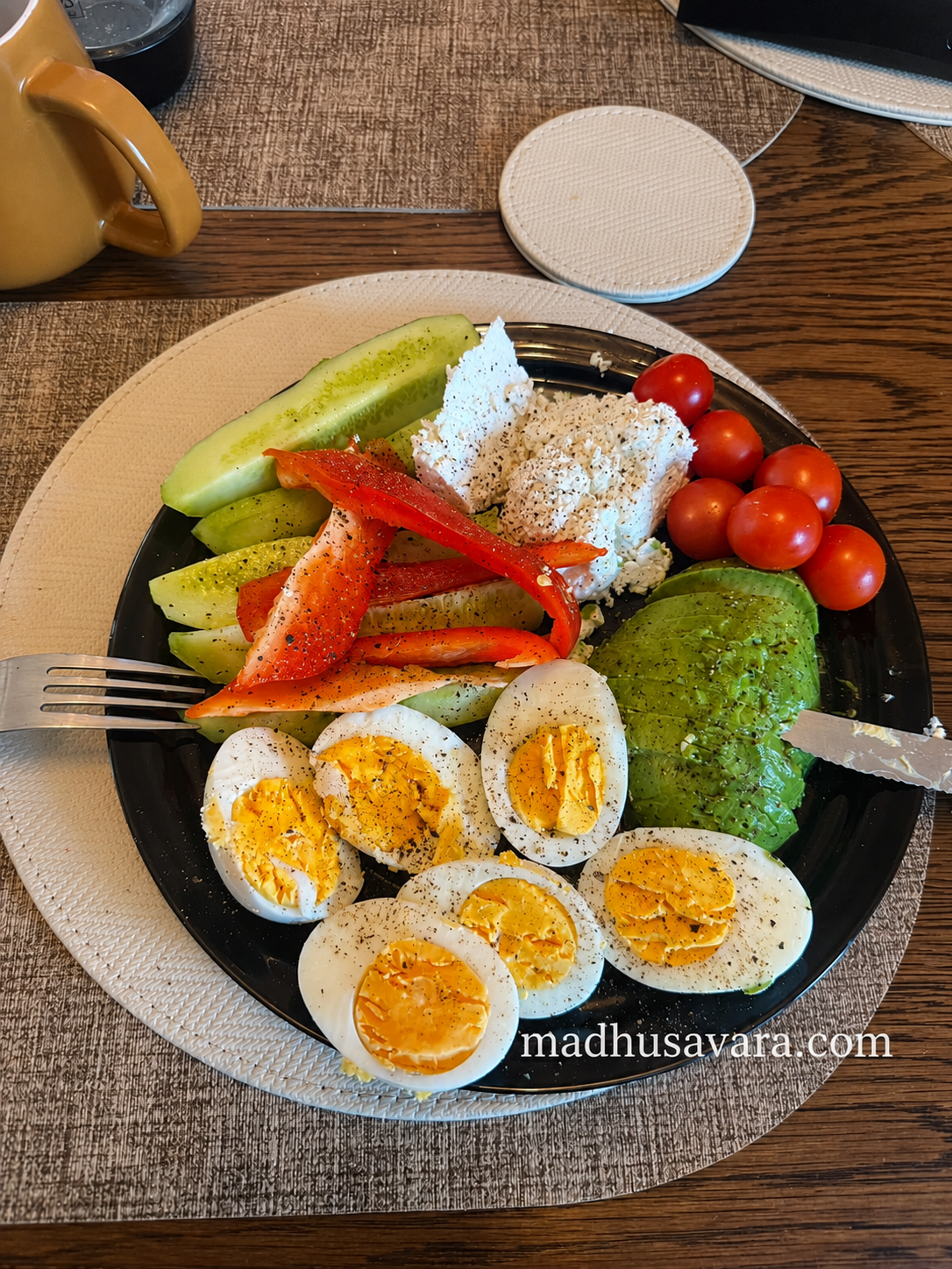 High protein breakfast plate with boiled eggs, Polish Twaróg cheese, avocado, cucumber, red bell pepper and cherry tomatoes