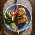Grilled Chicken Cheddar Basil Seeded Ciabatta Recipe | Seeded Ciabatta Sandwich 1 Grilled chicken cheddar basil seeded ciabatta sandwich with red bell pepper and fresh basil on a plate