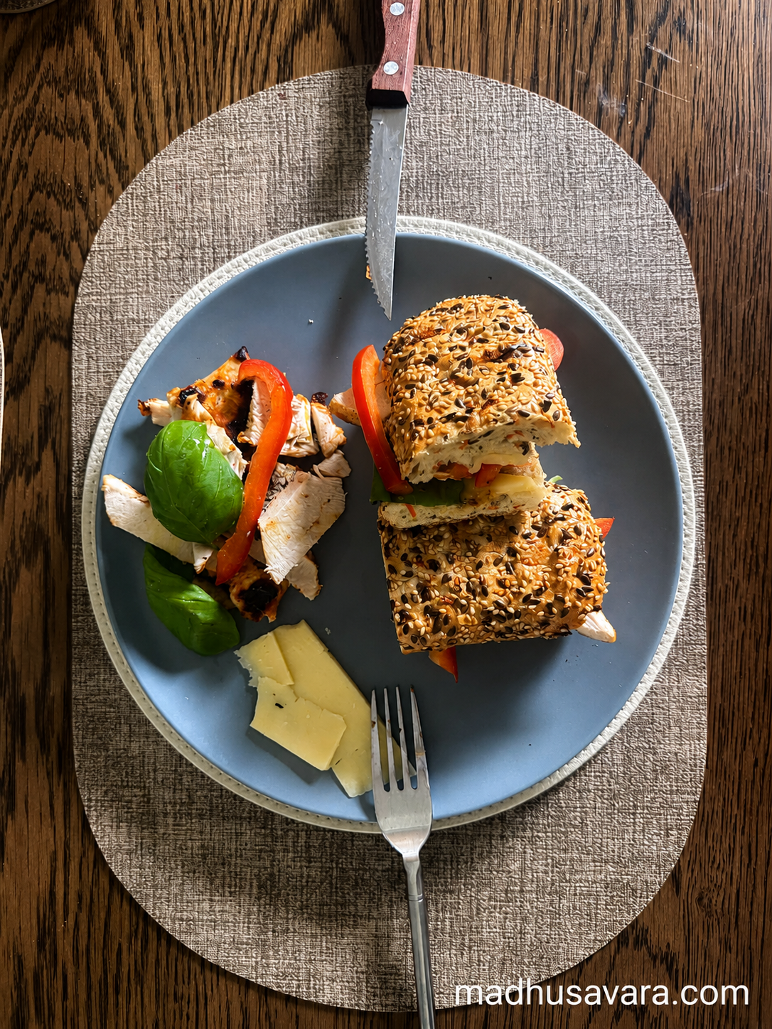 Grilled Chicken Cheddar Basil Seeded Ciabatta Sandwich Grilled chicken cheddar basil seeded ciabatta sandwich with red bell pepper and fresh basil on a plate