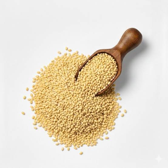 Kangni millet (foxtail millet) grains with wooden scoop